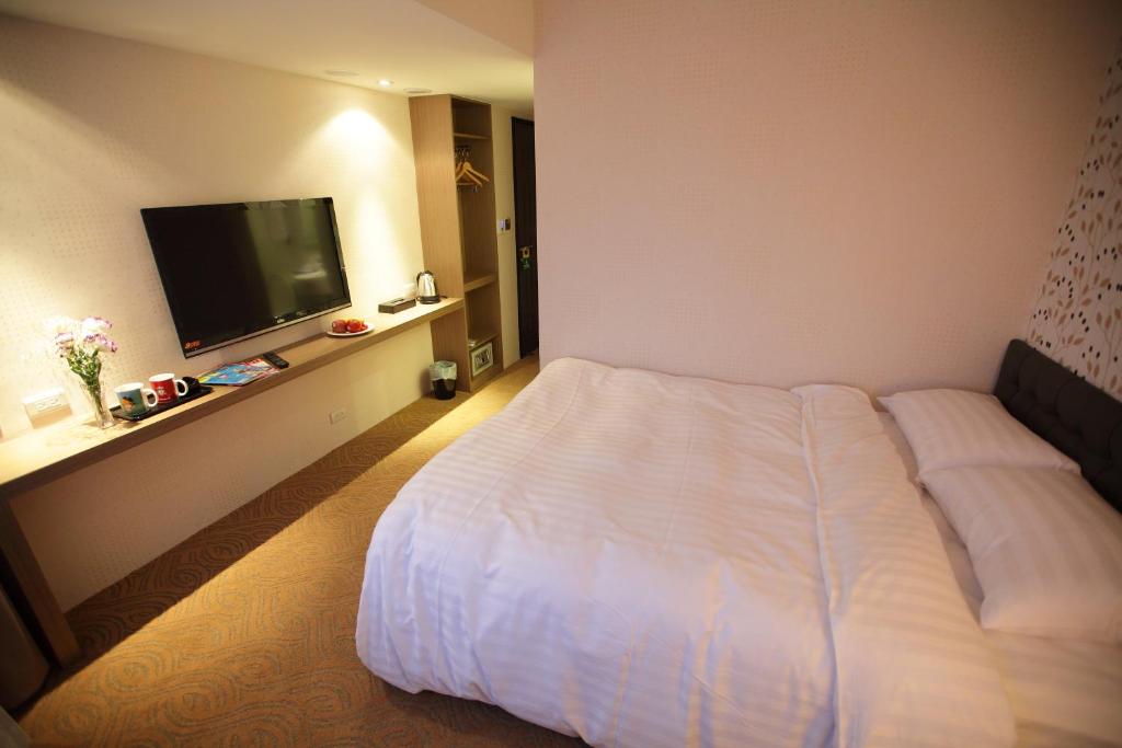 Postel nebo postele na pokoji v ubytování RF Hotel - Zhongxiao