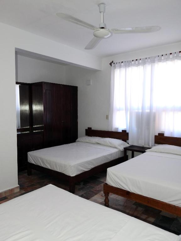 Postel nebo postele na pokoji v ubytování Don Luis Hostal - Sucursal Hidalgo - Tecolutla