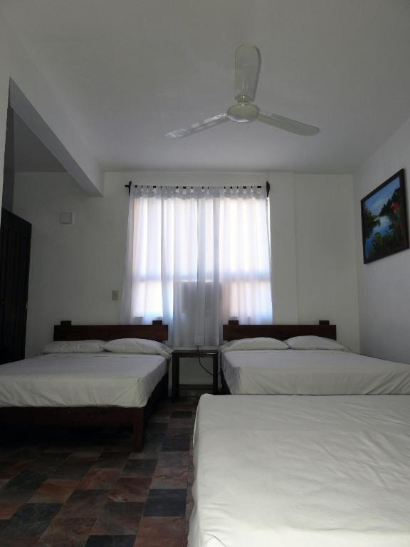 Postel nebo postele na pokoji v ubytování Don Luis Hostal - Sucursal Hidalgo - Tecolutla