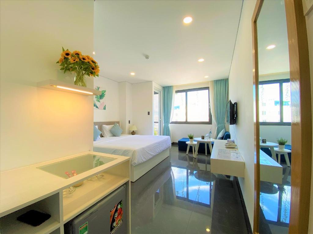 a hotel room with a bed and a bathroom at Olivia Hotel and Apartment in Nha Trang
