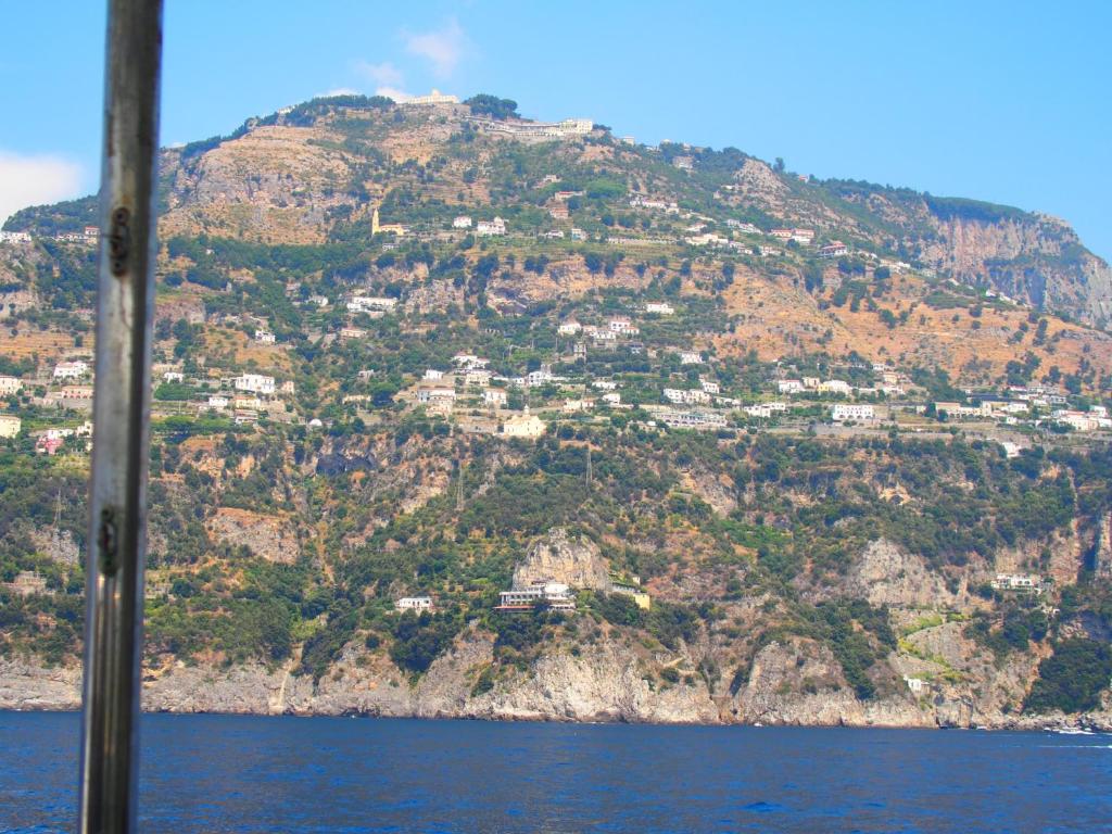 a mountain with houses on top of it at GIARDINO SUL MARE in Amalfi