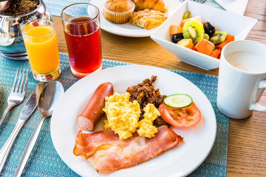 un tavolo con un piatto di prodotti per la colazione e bevande di Holiday Inn Express Sandton-Woodmead, an IHG Hotel a Johannesburg