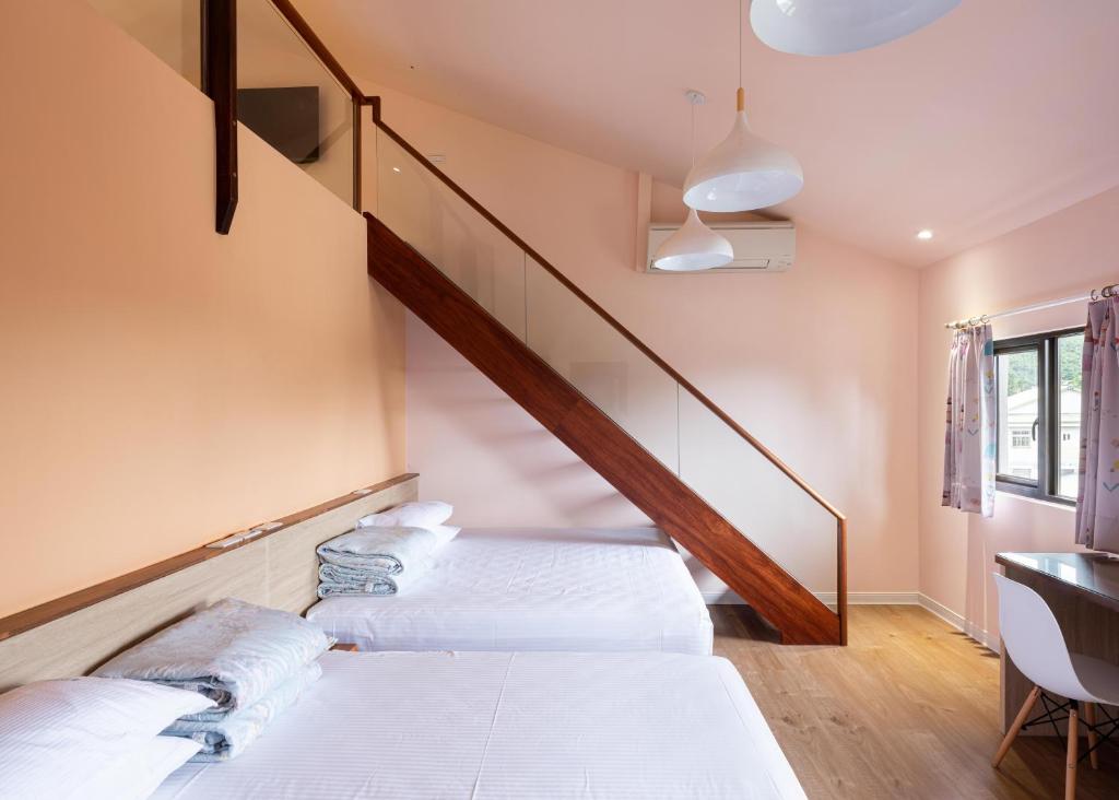 Postel nebo postele na pokoji v ubytování 名竹旅社 Minzu Hotel
