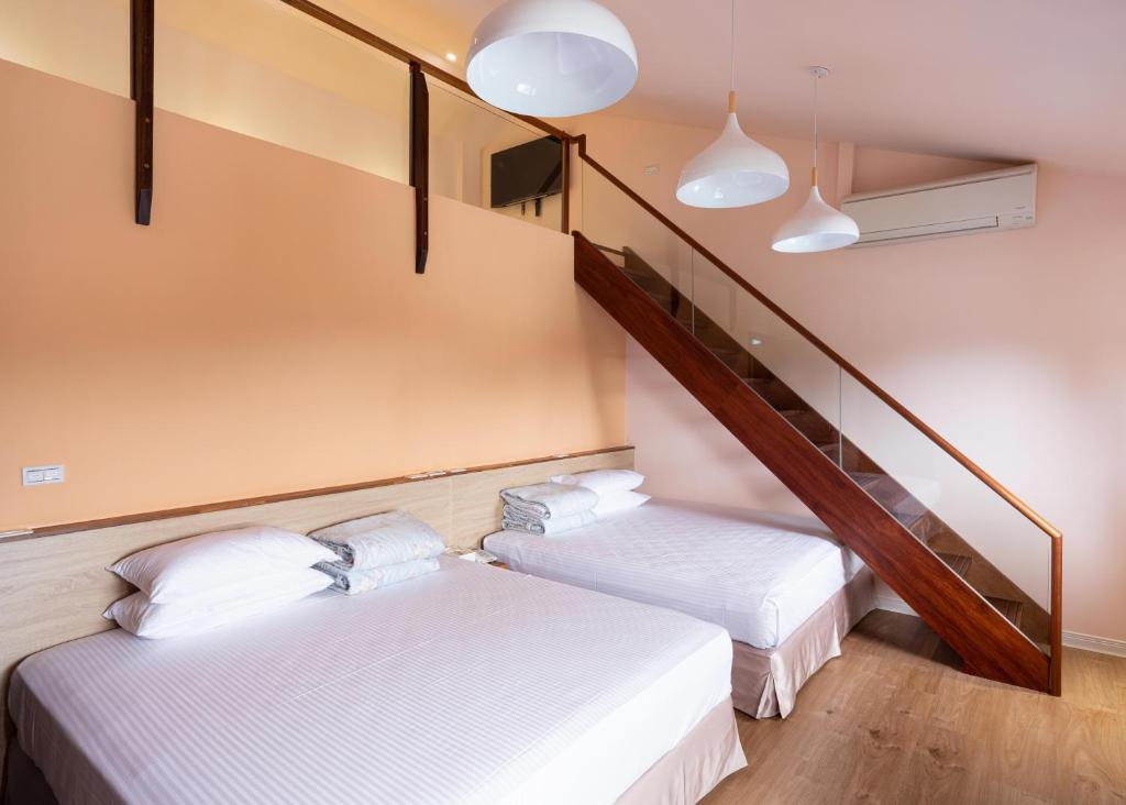 Postel nebo postele na pokoji v ubytování 名竹旅社 Minzu Hotel