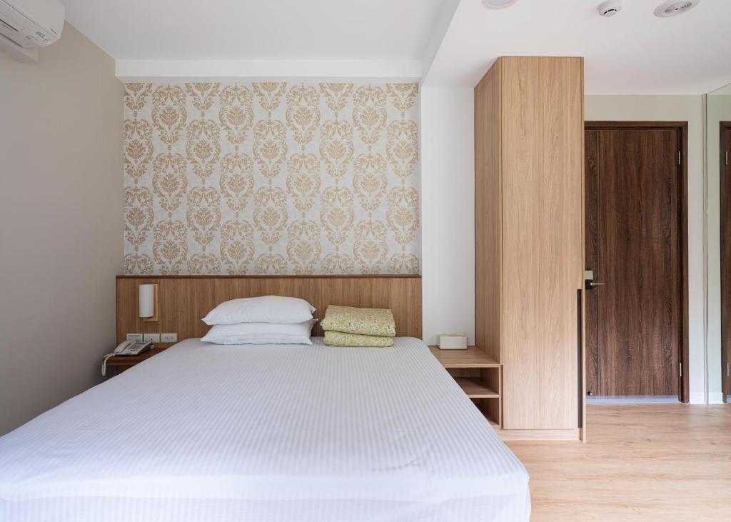 Postel nebo postele na pokoji v ubytování 名竹旅社 Minzu Hotel