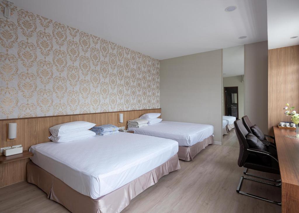 Postel nebo postele na pokoji v ubytování 名竹旅社 Minzu Hotel