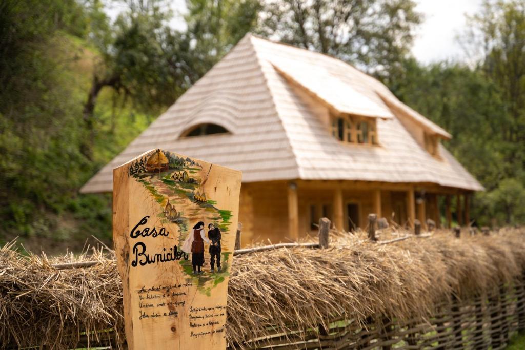 a house with a sign in front of it at Casa Bunicilor Apuseni in Geogel