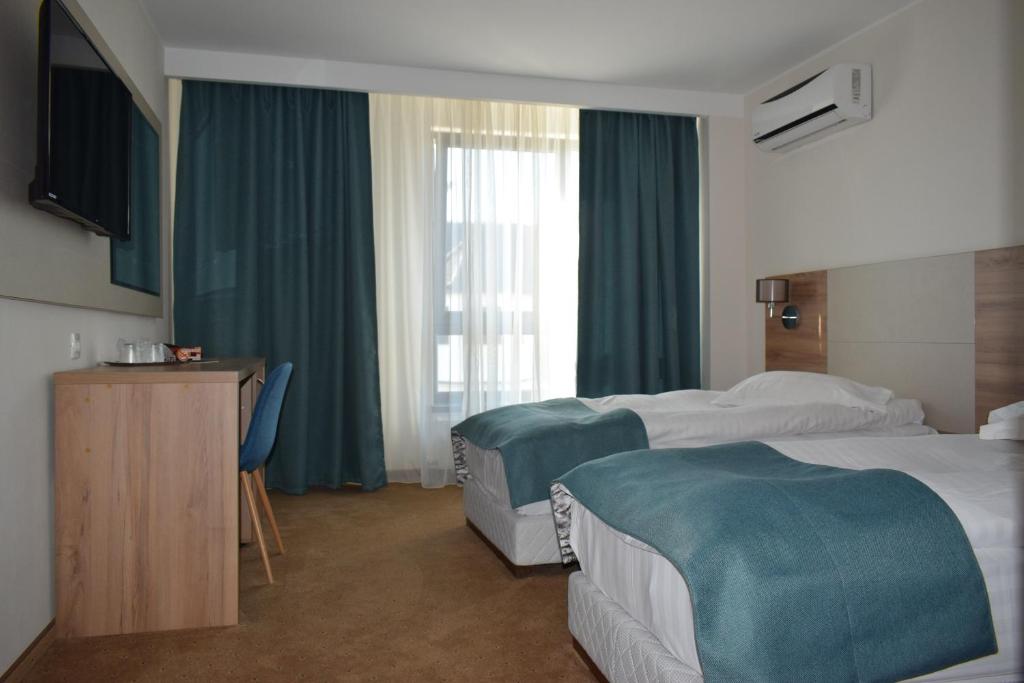 Postel nebo postele na pokoji v ubytování Hotel Regal