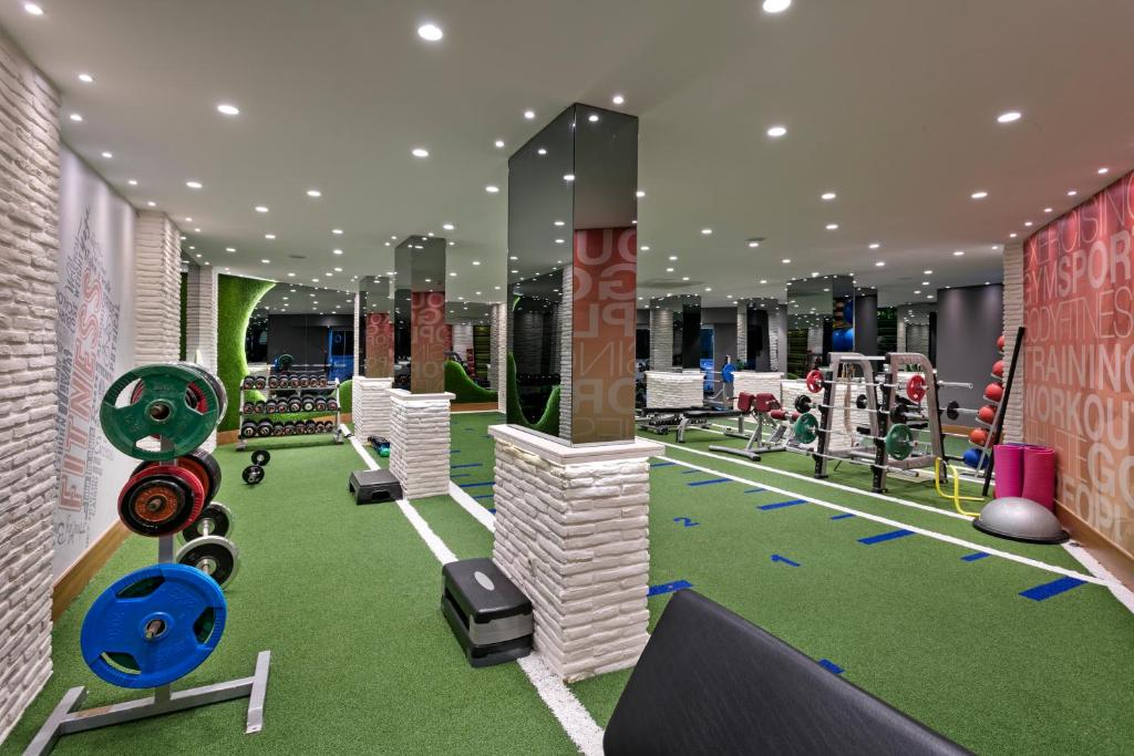 a fitness room with a gym with weights at Limak Arcadia Sport Resort Belek in Belek