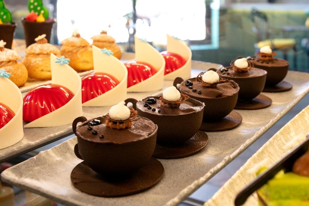 a display of chocolate cupcakes on a table at Limak Arcadia Sport Resort Belek in Belek