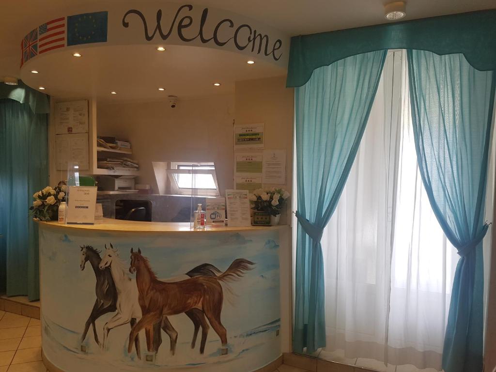 a store with a counter with horses painted on it at Hotel Arco Romana in Milan