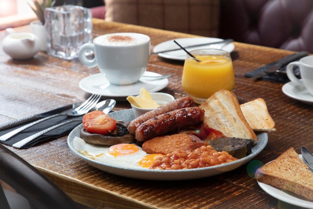 a plate of breakfast food with eggs sausage bread and toast at The Bold Hotel; BW Signature Collection in Southport