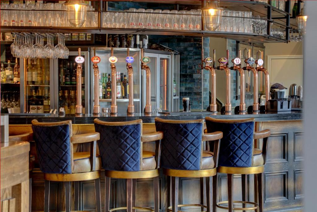 a bar with five bar stools in a restaurant at The Bold Hotel; BW Signature Collection in Southport