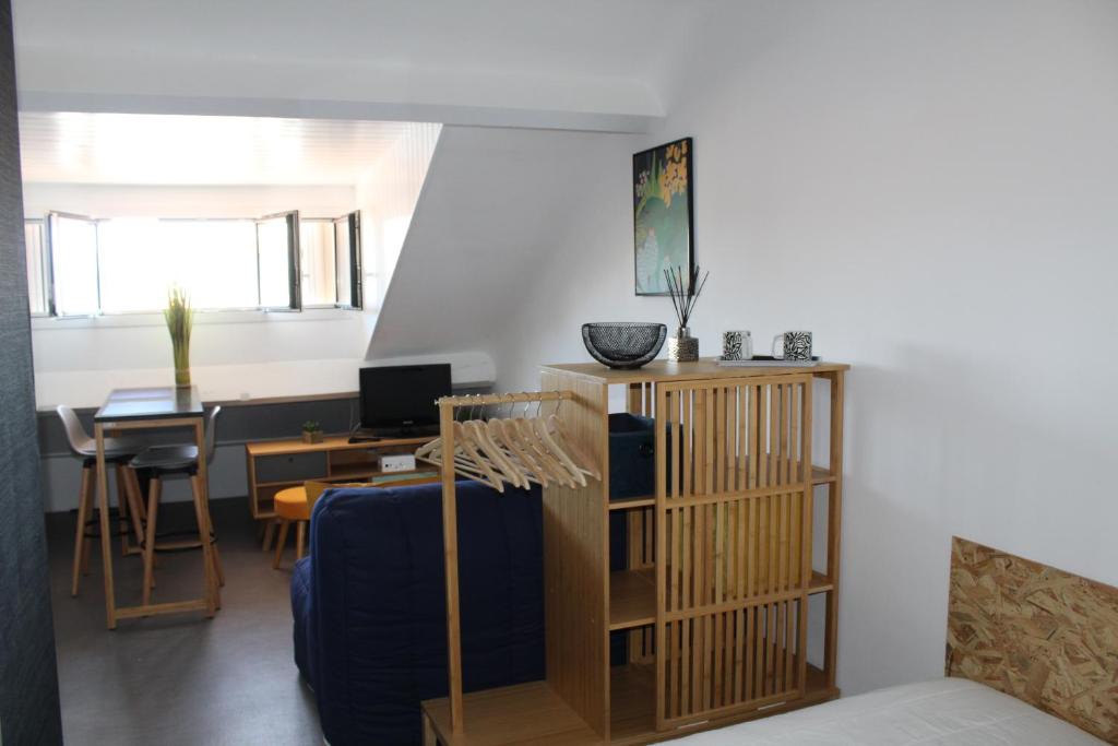 a living room with a blue couch and a table at Studio hyper centre avec vue sur les Pyrénées in Saint-Jean-de-Luz