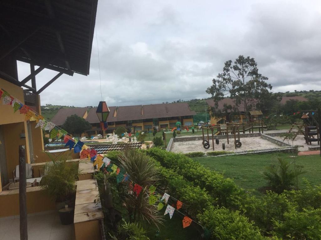 a view of a park with a fence with flags at Flat Luxo em Gravatá Winterville in Gravatá