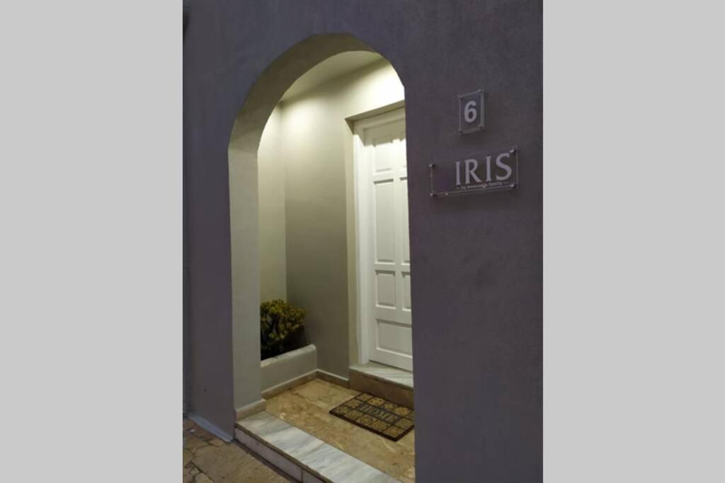 an archway leading to a door with a sign on it at IRIS by Amanakis Family in Hersonissos