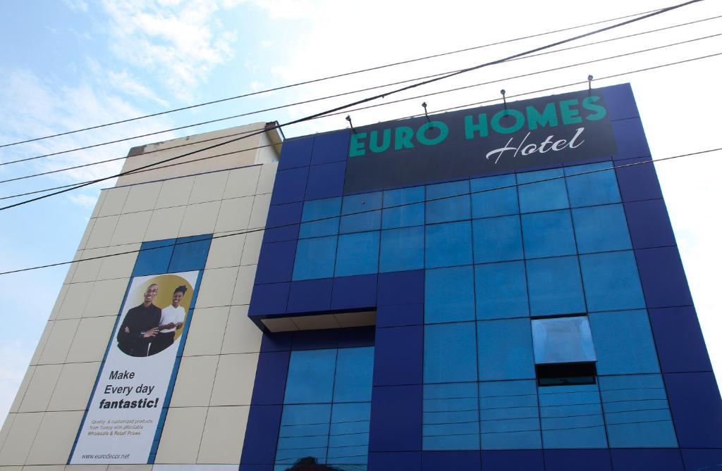 a building with a sign on the side of it at Euro Homes Hotel in Accra