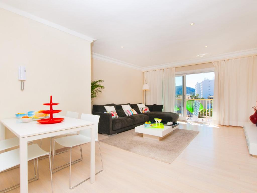 a living room with a couch and a table at Apartment Corales de Mar, at Alcudia Beach in Alcudia