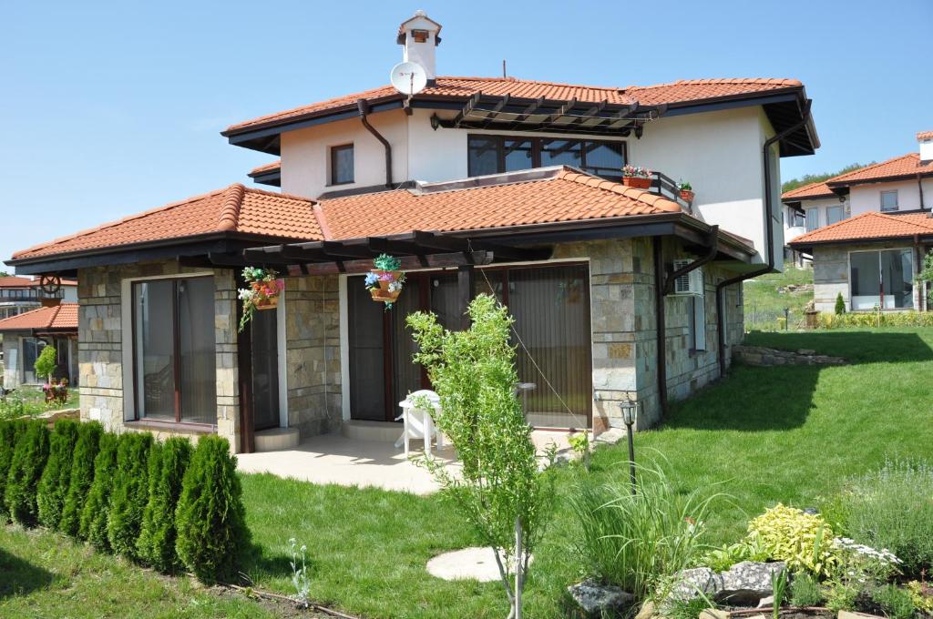 a house with a garden in front of it at Villa on the Black Sea in Sunny Beach