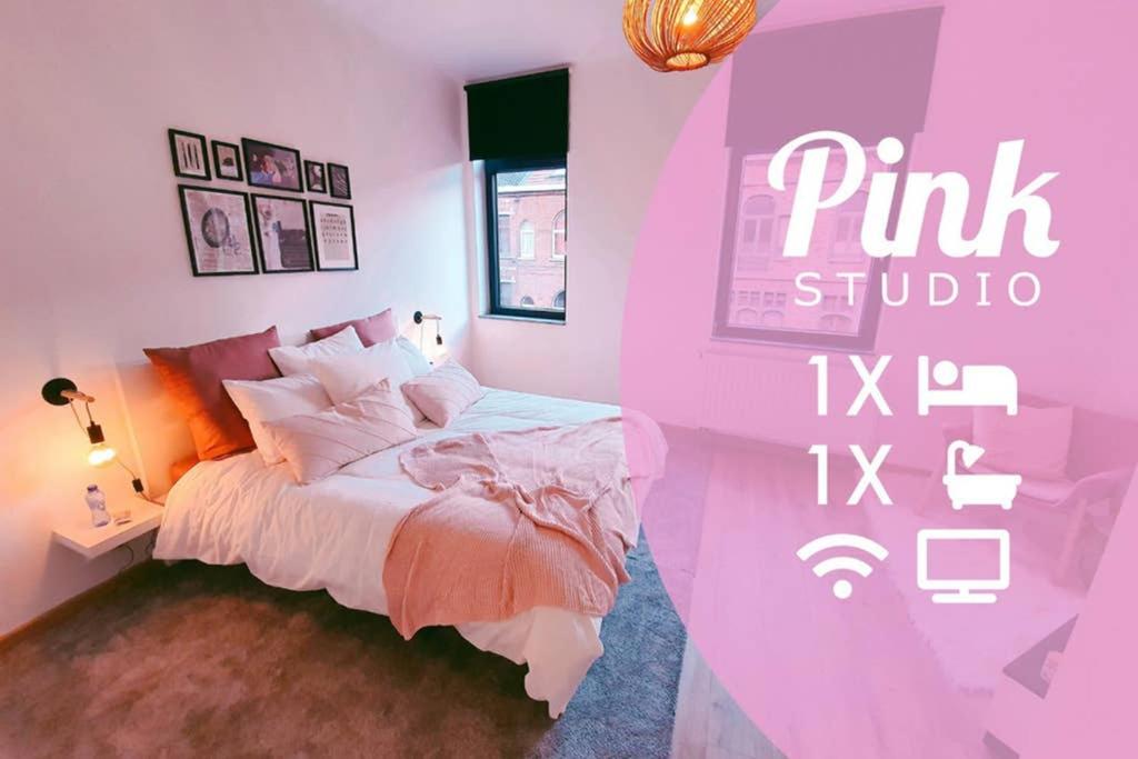 a pink bedroom with a bed and a pink studio sign at Pink studio Mons ✓ TOP position ! in Mons