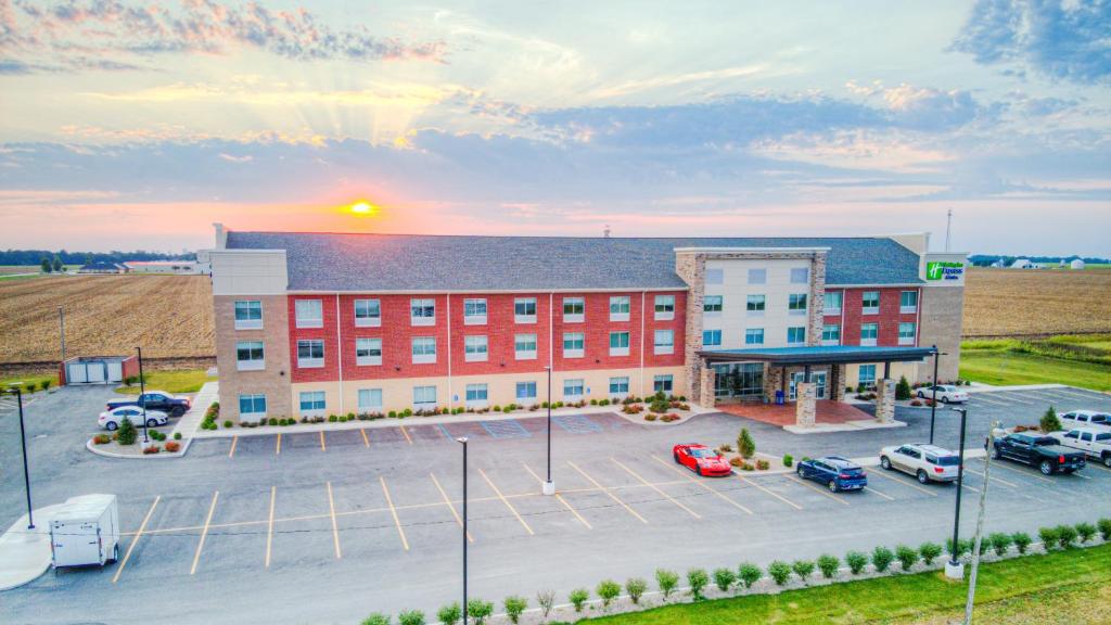 an aerial view of a building with a parking lot at Holiday Inn Express & Suites - Remington, an IHG Hotel in Remington