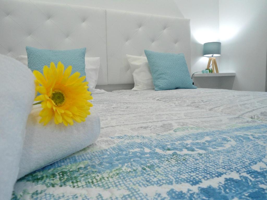 um quarto com uma cama com uma flor amarela em Town Apartment no Funchal