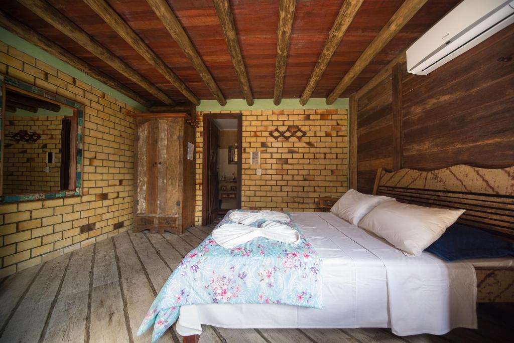 Cama ou camas em um quarto em Pousada Favo De Mel