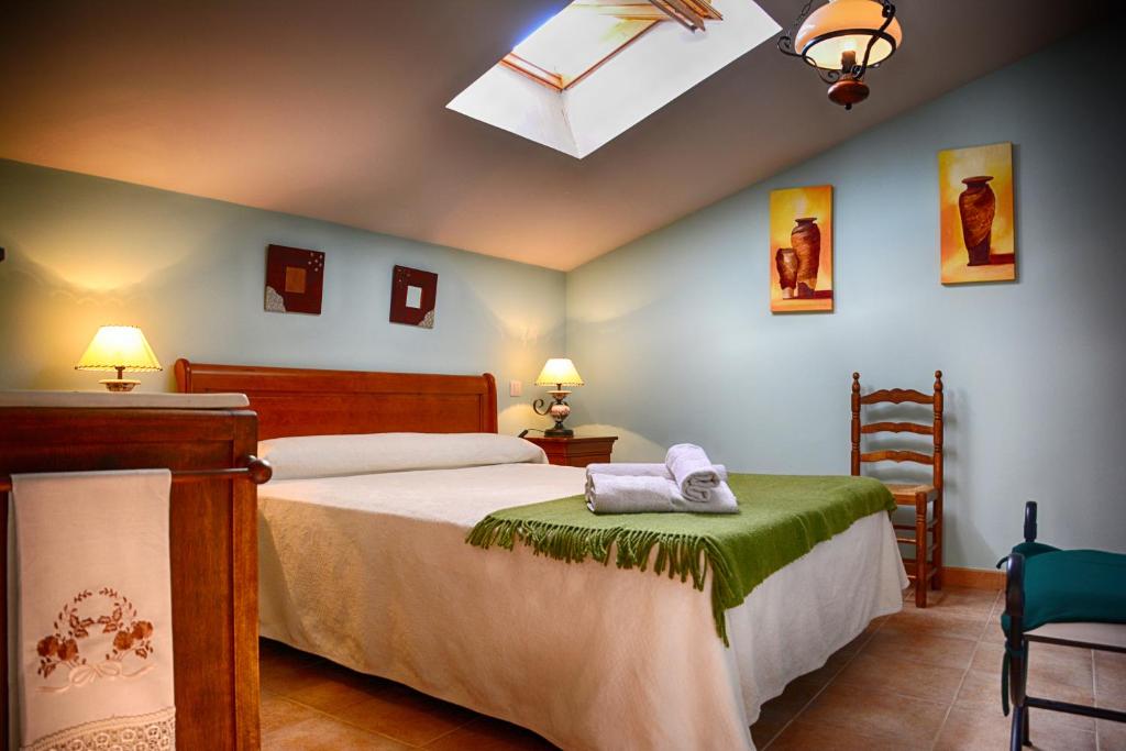 a bedroom with a bed and a desk and a window at Casa Rural La Morena in Castroverde de Cerrato