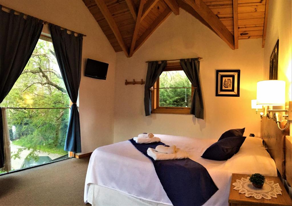 Postel nebo postele na pokoji v ubytování Apart Hotel del Pellin