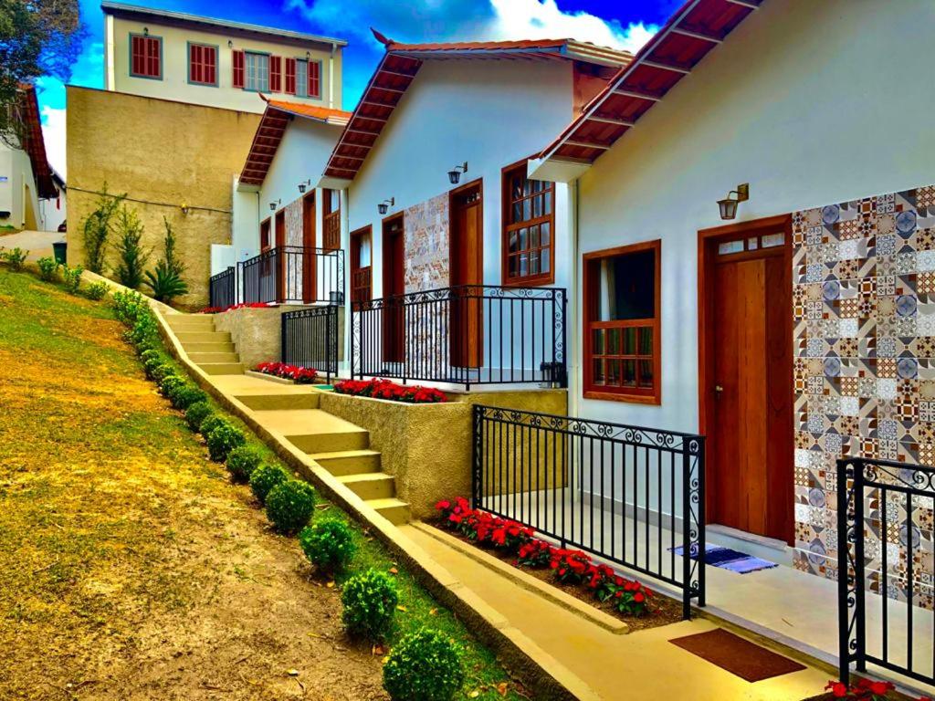 a row of houses with flowers in front of them at Pousada Vila Catarina in Ouro Preto