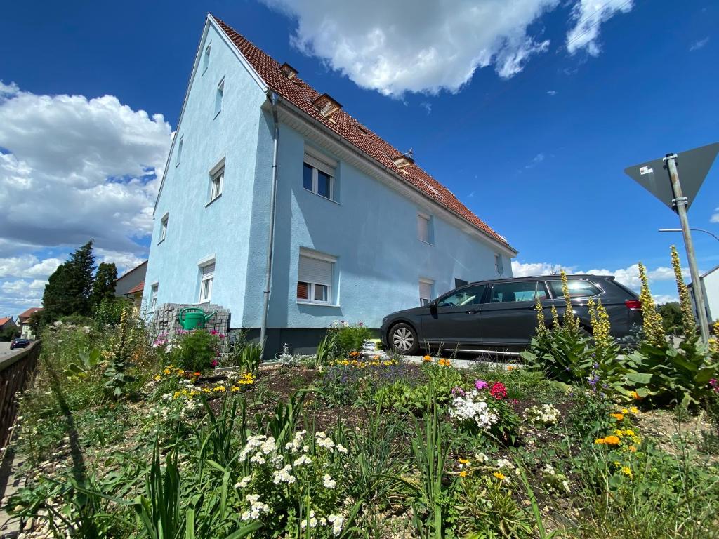 a blue building with a car parked next to it at Wanderlust in Bisingen