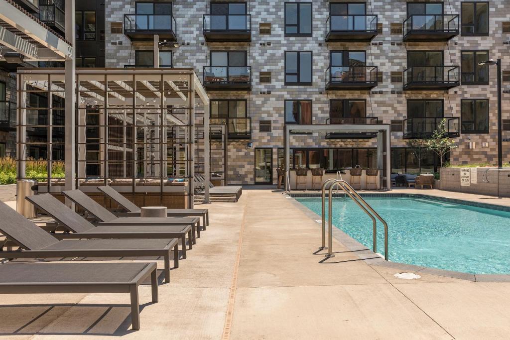 a pool in a building with benches next to a building at Sonder at East End in Minneapolis