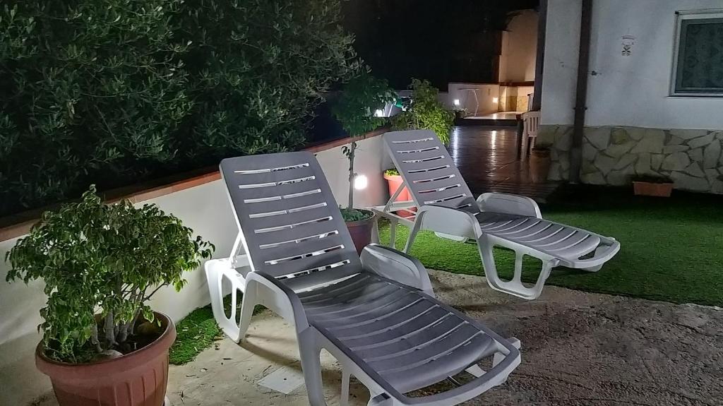 a pair of chairs sitting on a patio at Locazione Turistica Le Fate in Agrigento