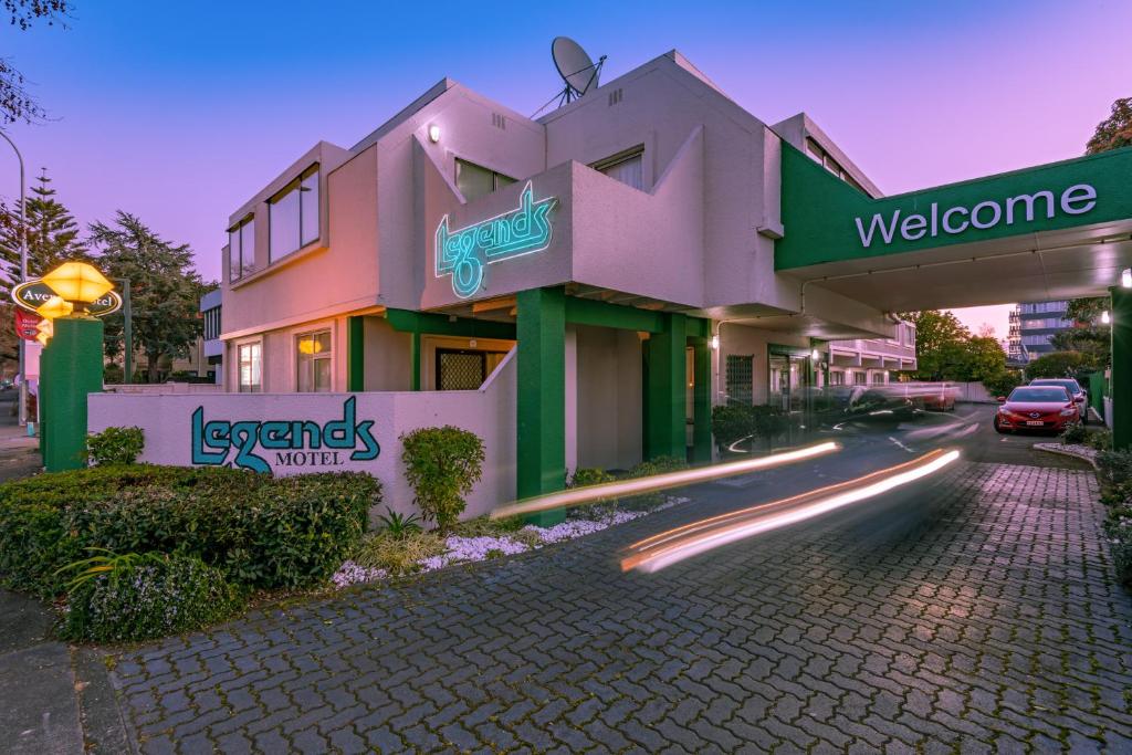 a building on a street with a road at Legends Motel in Palmerston North