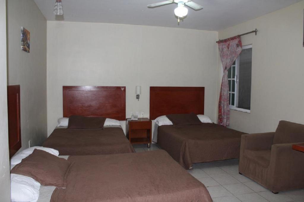 Postel nebo postele na pokoji v ubytování Hotel Gina
