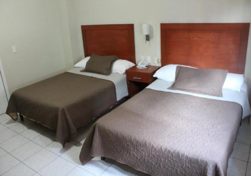 Postel nebo postele na pokoji v ubytování Hotel Gina