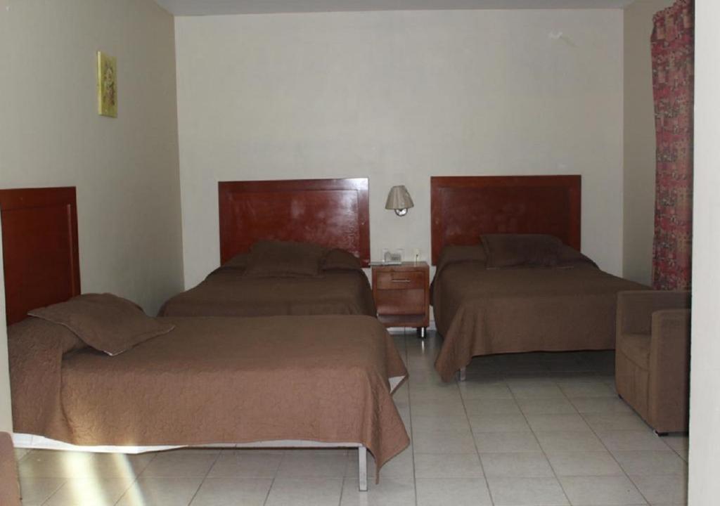 Postel nebo postele na pokoji v ubytování Hotel Gina
