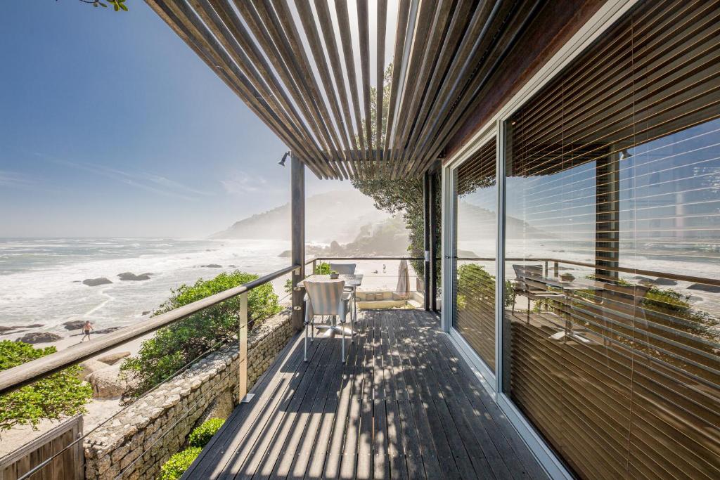 a house with a balcony with a view of the ocean at Wixy in Cape Town