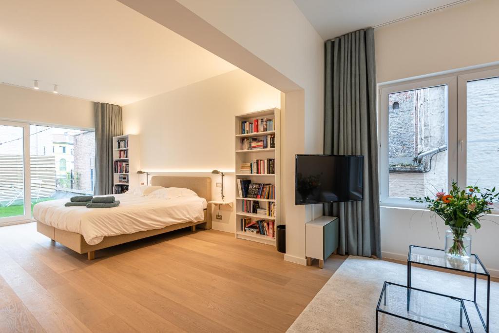 um quarto com uma cama e uma televisão de ecrã plano em Gepetto's - Beautiful stay in the Historic centre of Ghent - em Gante