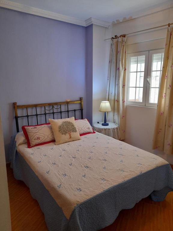a bedroom with a bed with two pillows on it at CAMINO A MONASTERIO in Alhama de Aragón
