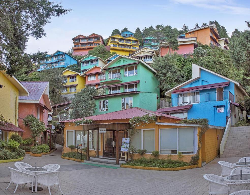 a group of colorful houses on a hill at Club Mahindra Mussoorie in Mussoorie