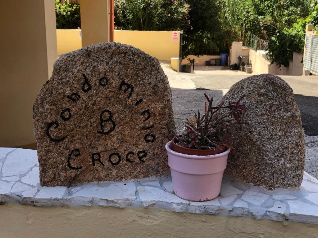 two large rocks with a plant in a pot at Da.Da. House in La Maddalena