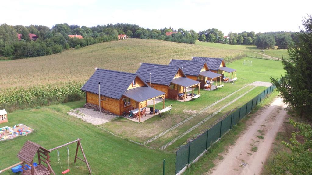 widok na rząd domków letniskowych na wzgórzu w obiekcie Domki Kosewo w mieście Mrągowo