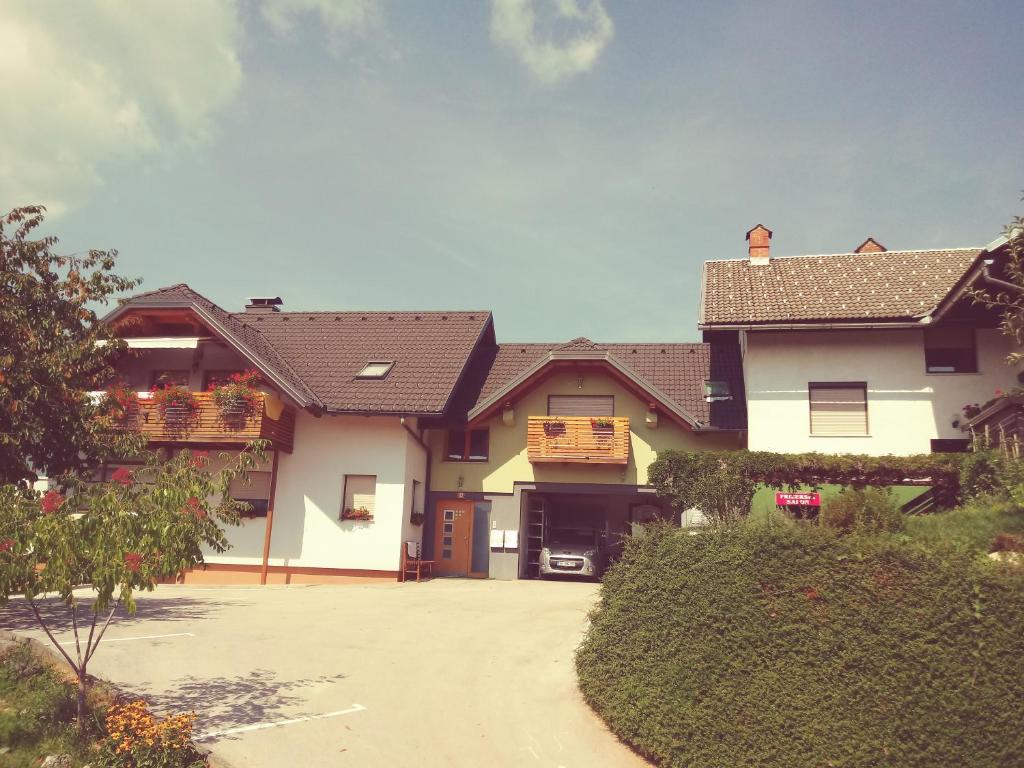 a large house with a driveway in front of it at Apartma Šmid in Škofja Loka