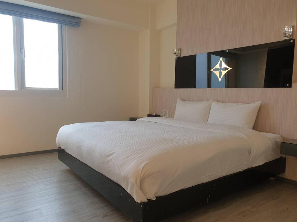 Postel nebo postele na pokoji v ubytování Walker Hotel - Chenggong