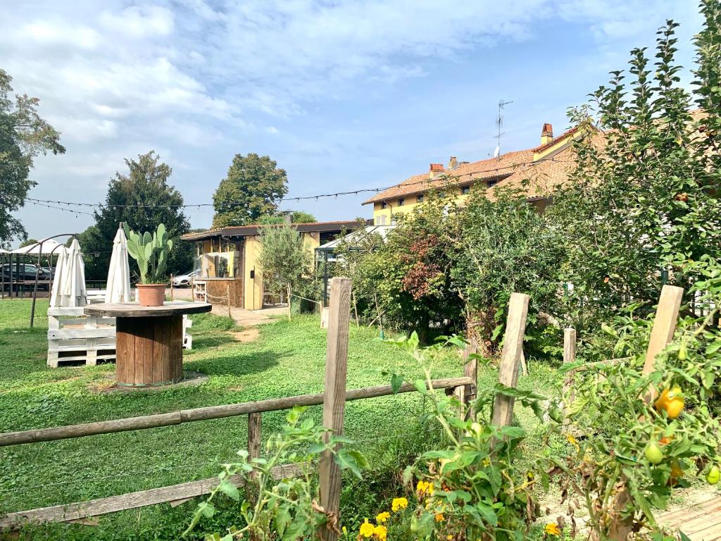 un jardín con una mesa y una valla en Cascina Bellaria, en Milán