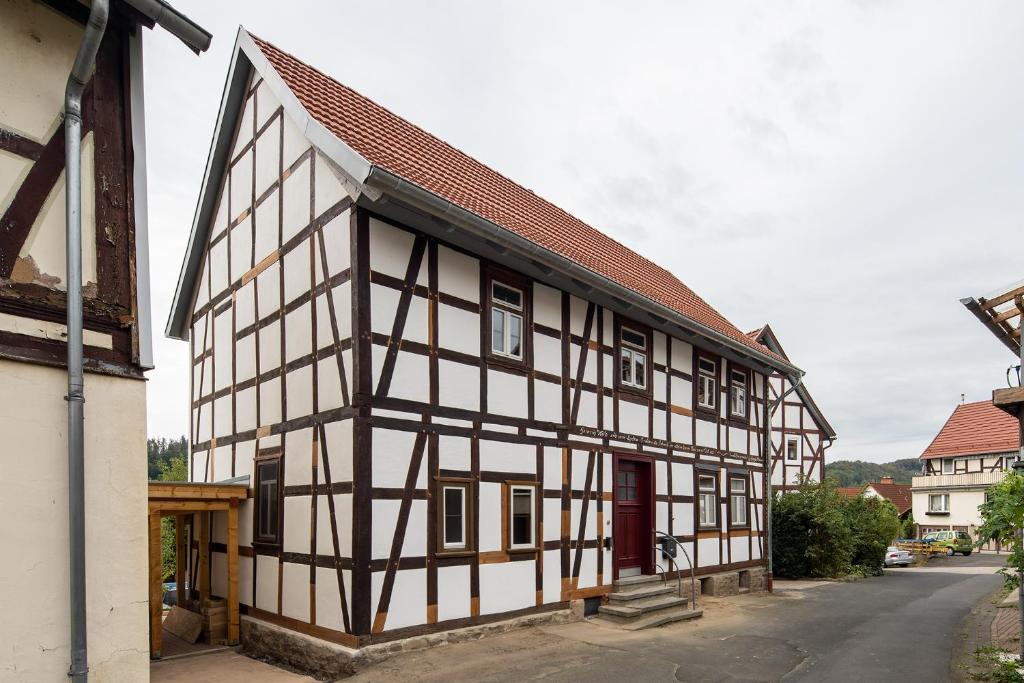 a black and white building with a red roof at Auszeithaus Edertal in Kleinern