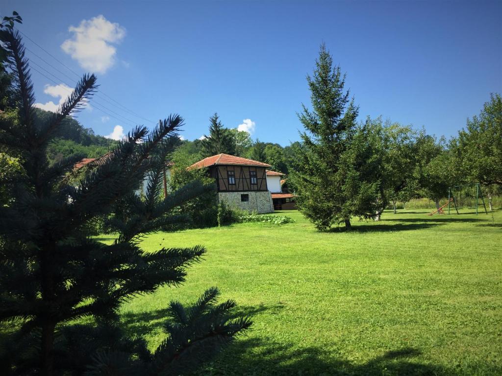 a house in the middle of a field with trees at Etno Kuća - Rakić in Svrljig
