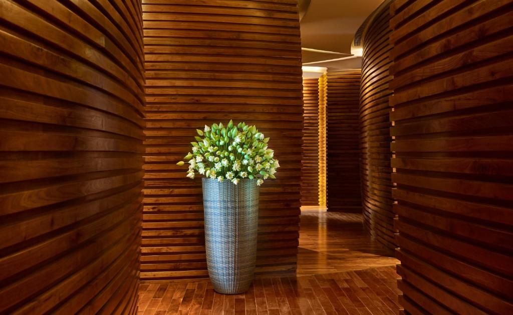 a vase with a plant in a hallway at The Reverie Saigon in Ho Chi Minh City