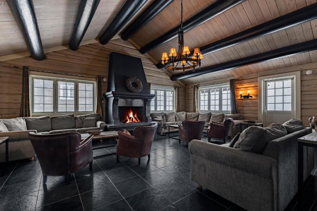 sala de estar con sofás y chimenea en Storelia, en Hemsedal